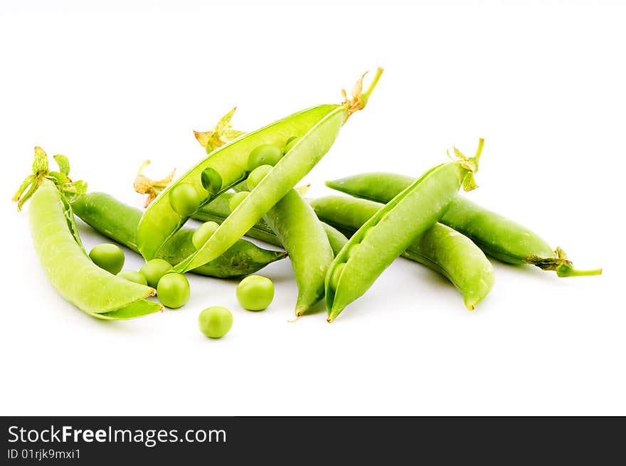 Pods of fresh green peas on a white background