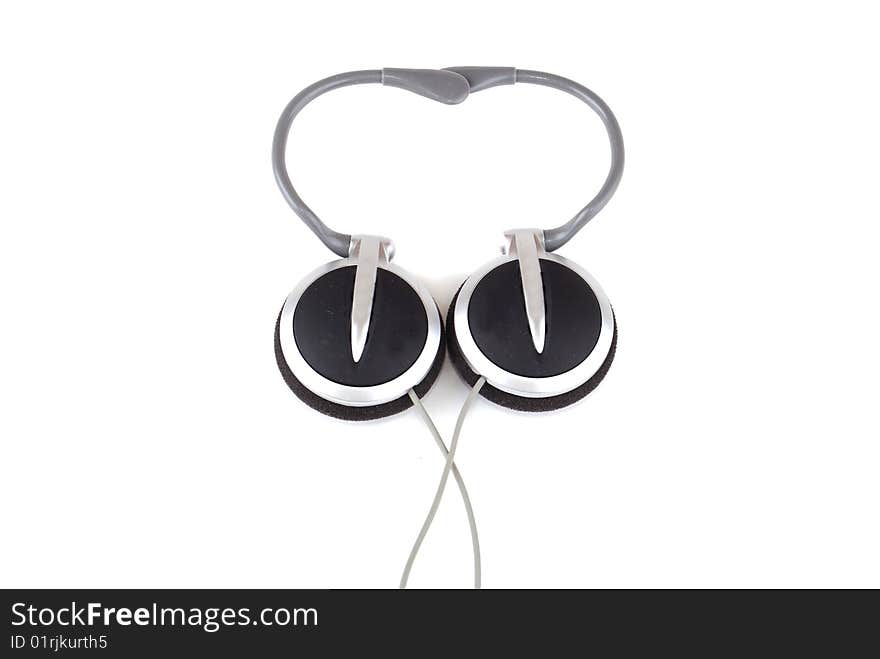 Small easy ear-phones of silvery colour with a cable and the plug.