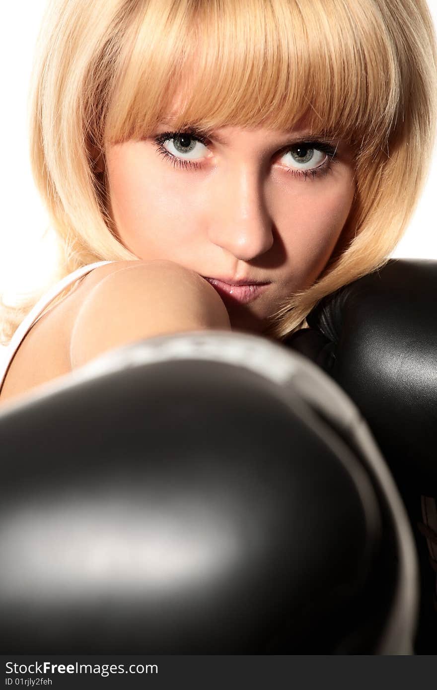 Close-up portrait of girl with black boxing gloves. Close-up portrait of girl with black boxing gloves