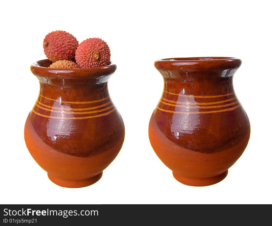 Fresh ripe litchi in jug isolated on white background.