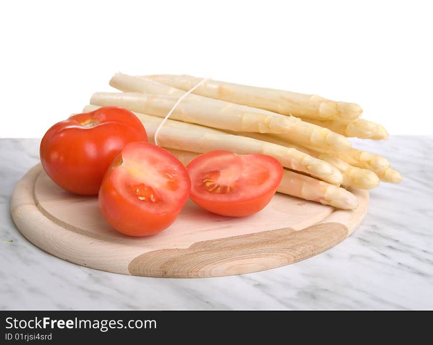 Fresh asparagus and tomatos isolated on white background.