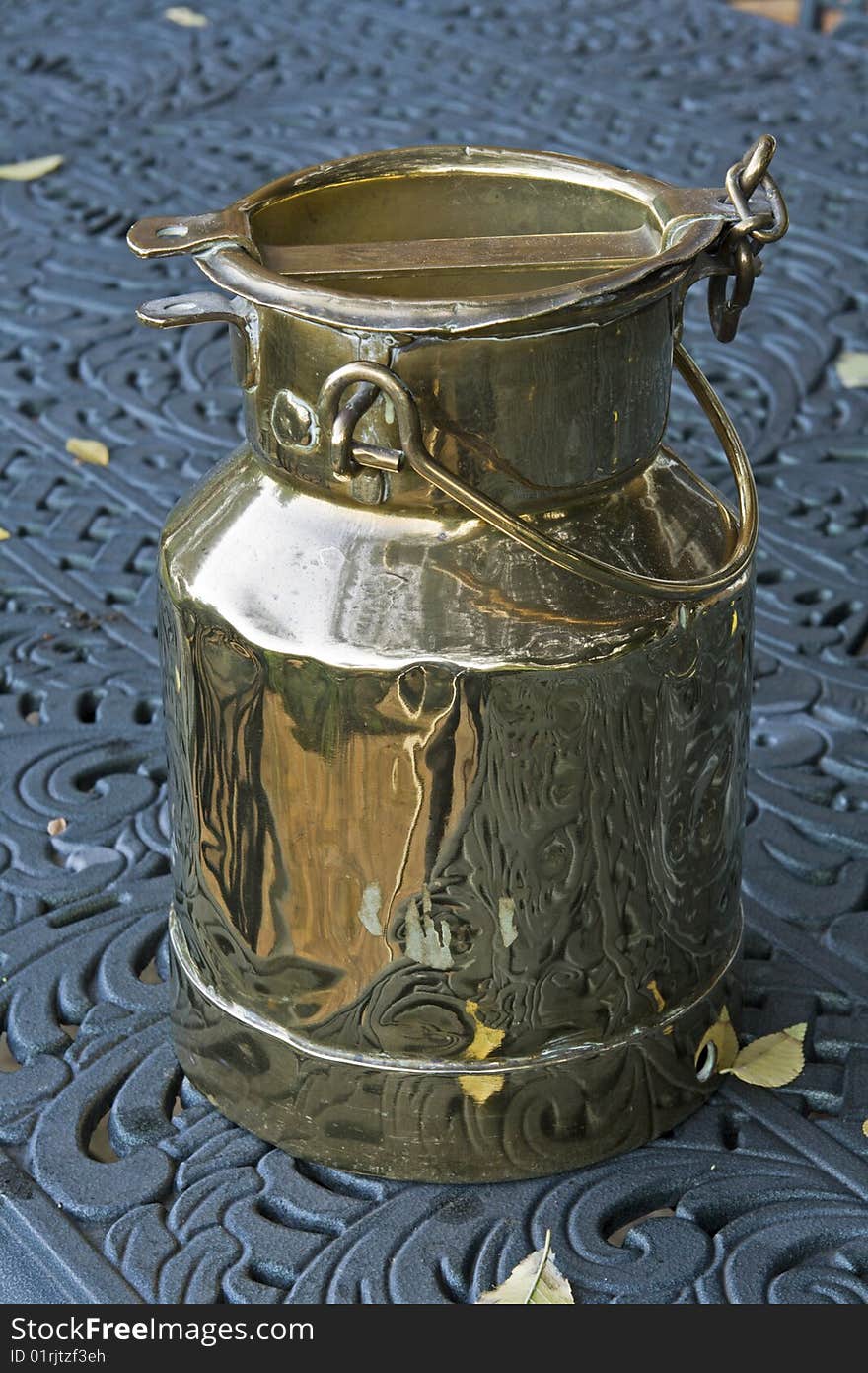 A vintage brass plated milk pail or milk container used to transport milk from farms in South Africa. A vintage brass plated milk pail or milk container used to transport milk from farms in South Africa