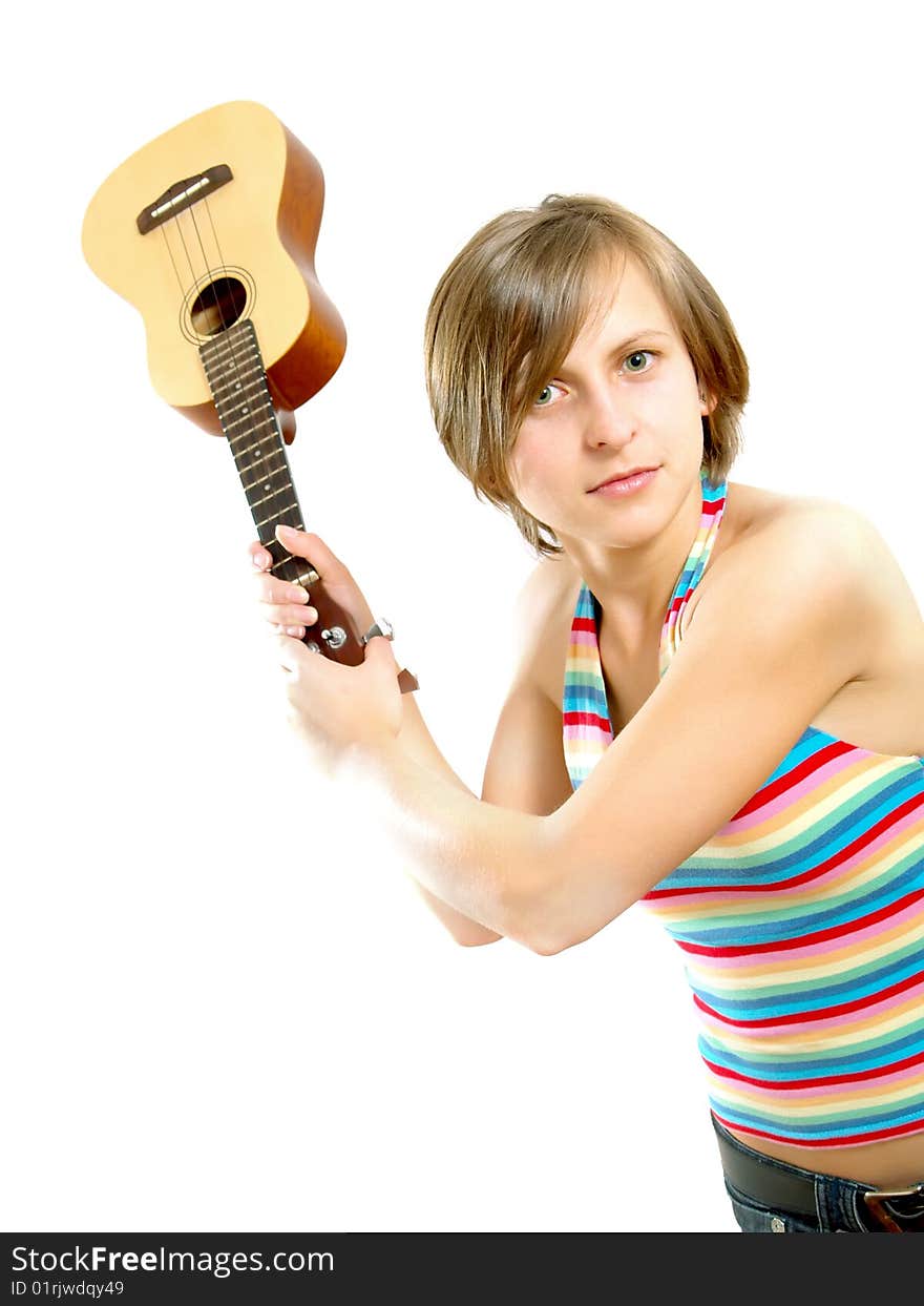 Portrait of a pretty Caucasian blond girl with a nice colorful striped summer dress who is angry and she want to fight with an ukulele (small Hawaiian guitar). Isolated on white. Portrait of a pretty Caucasian blond girl with a nice colorful striped summer dress who is angry and she want to fight with an ukulele (small Hawaiian guitar). Isolated on white.