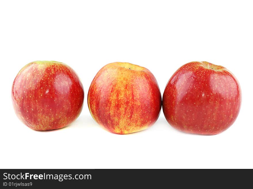 Red juicy apples with yellow points on sides.