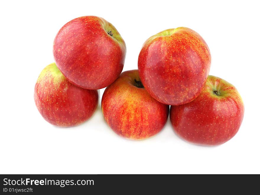 Red juicy apples with yellow points on sides.