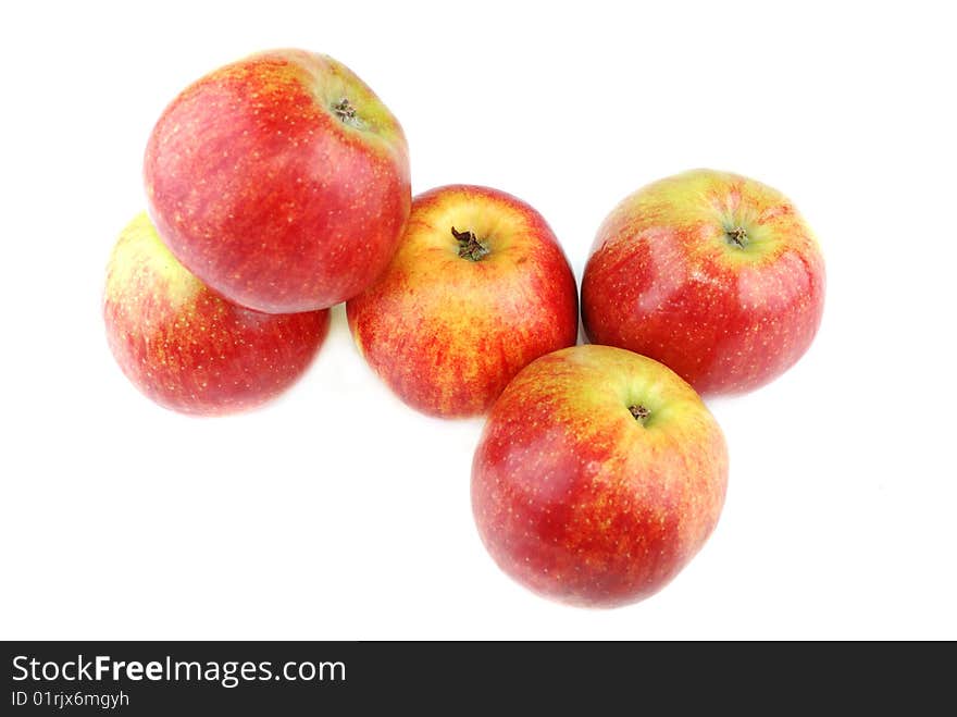 Red juicy apples with yellow points on sides.