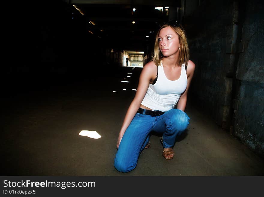 Beautiful girl sits in the dark tunnel. Beautiful girl sits in the dark tunnel