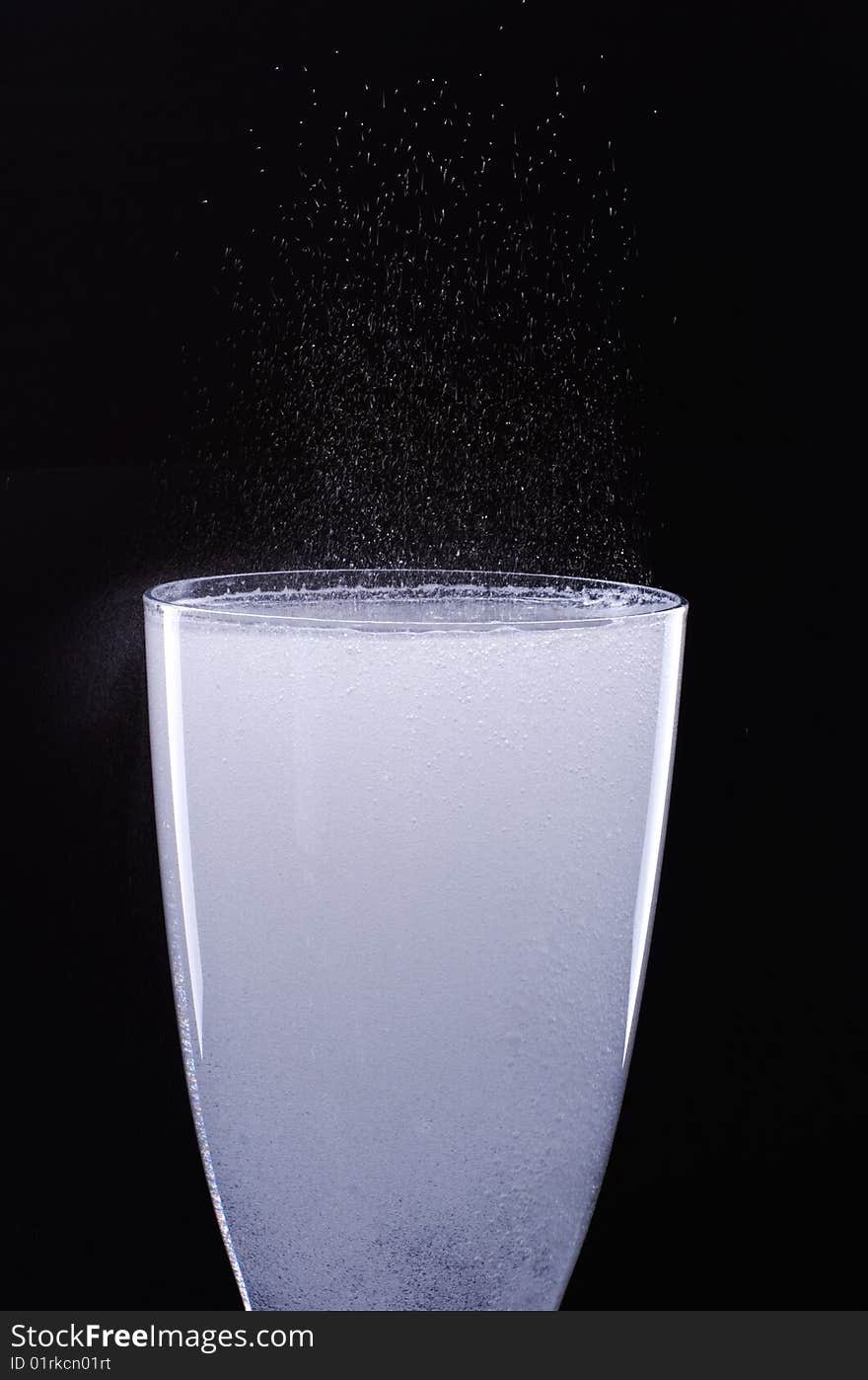 Glass with bubbles on a black background