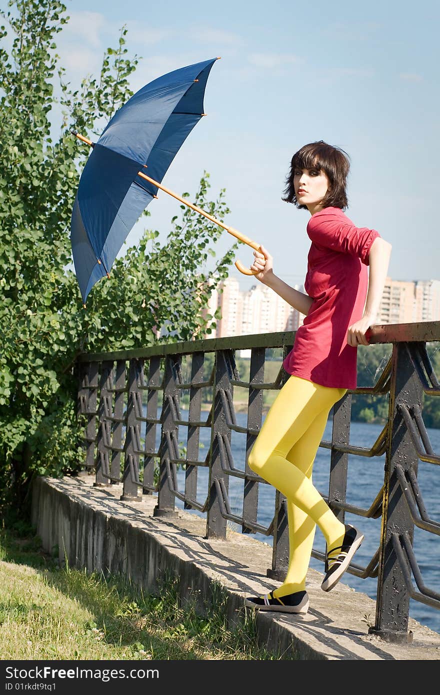 Bright fashionable girl with the umbrella.