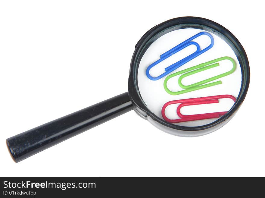 Magnifier and three paper clips on a white background