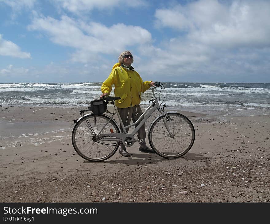 Senior woman with bicycle on sea shore. Senior woman with bicycle on sea shore