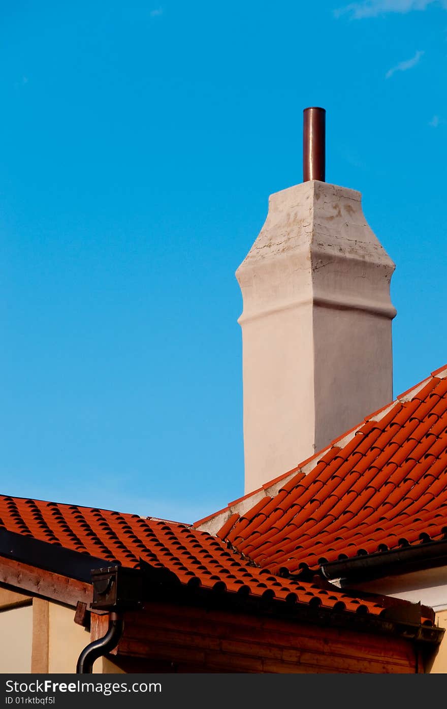 Closeup of red roof and big rustical chimney. Closeup of red roof and big rustical chimney