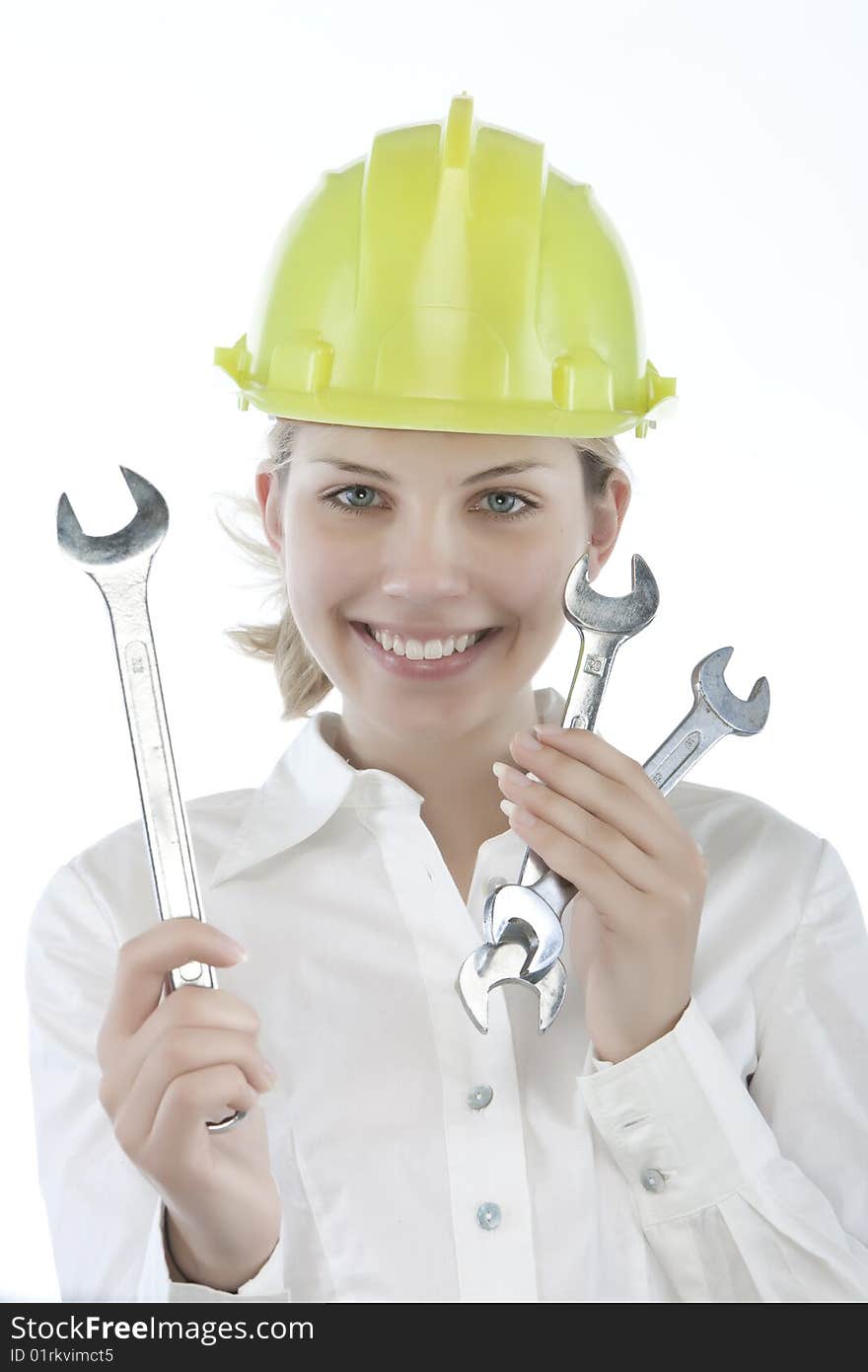 Pretty girl with helmet and wrench over white background