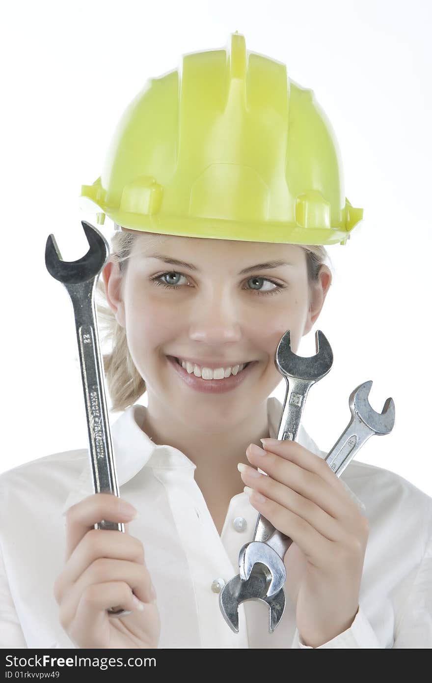 Pretty girl with helmet and wrench over white background