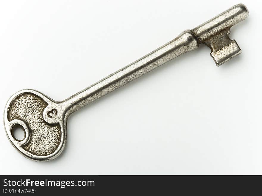 Isolated closeup of old shiny key. Isolated closeup of old shiny key