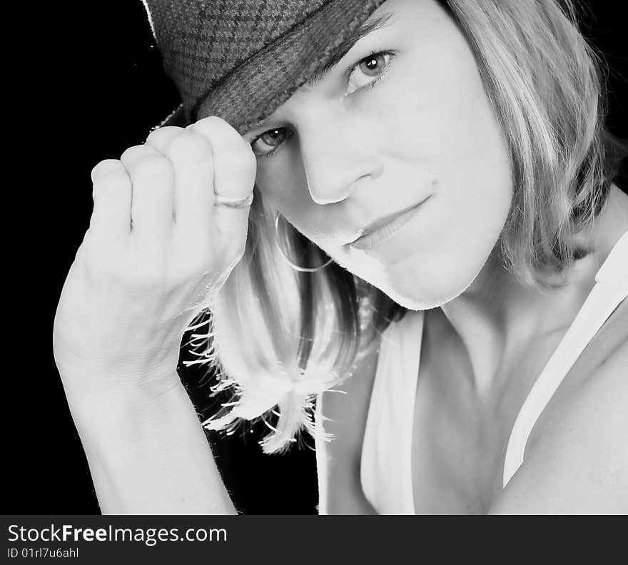 A woman posing with a hat. A woman posing with a hat.