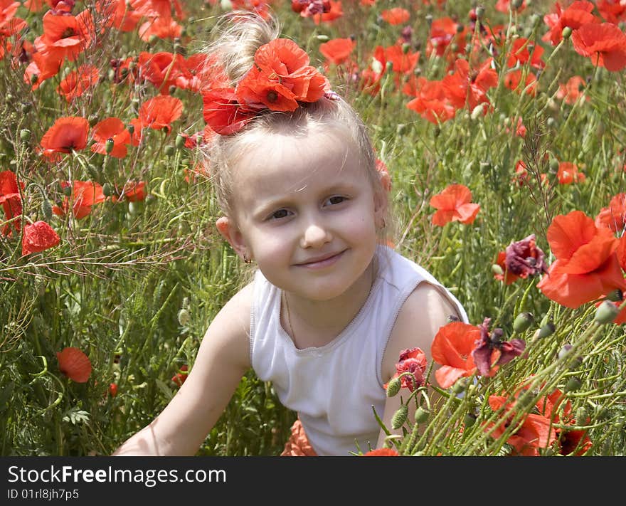 On the image there is a little girl. She is in poppys. On the image there is a little girl. She is in poppys.