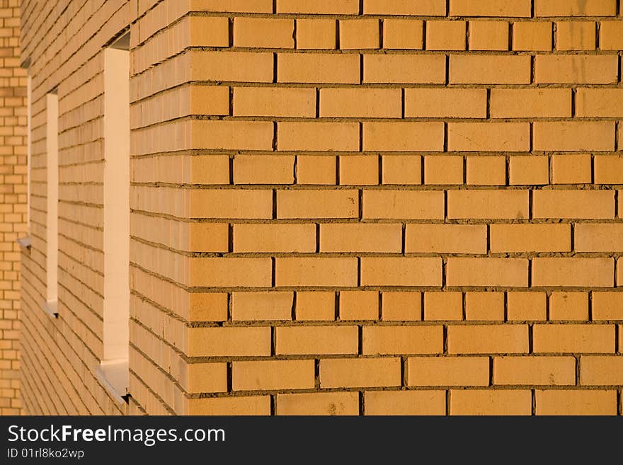 Yellow brick wall in sunset light as it is