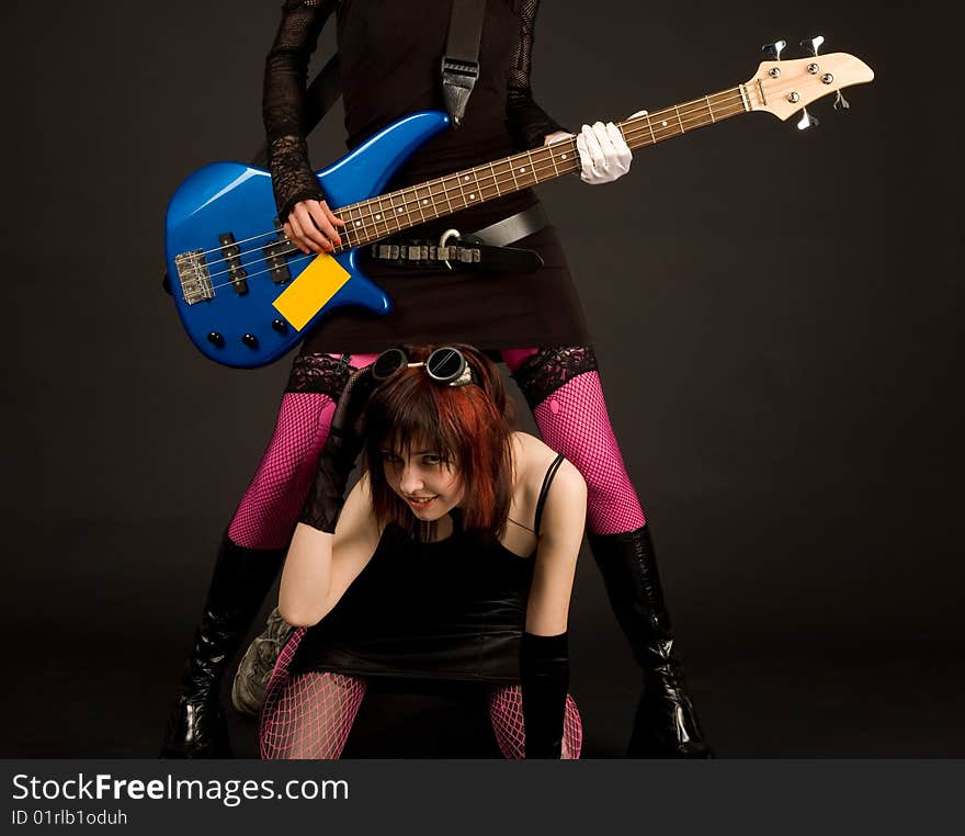 Rock girls with guitar, studio shot