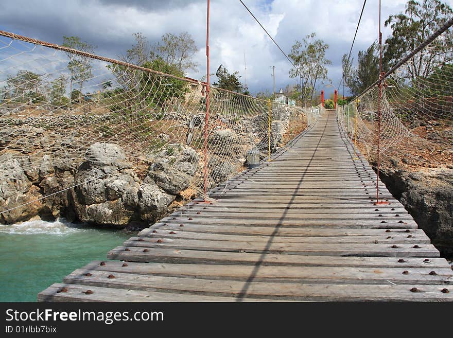 Old wooden hanging bridge over a bay