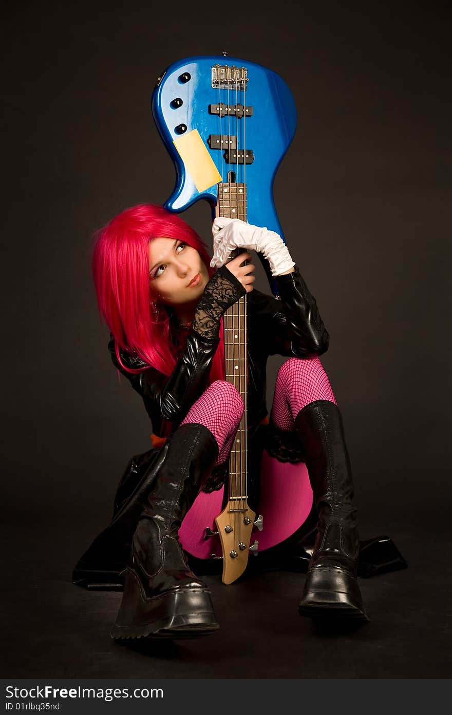 Romantic girl with guitar, studio shot