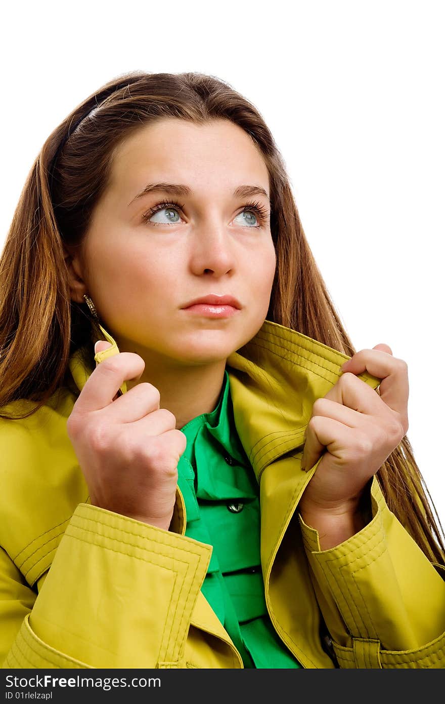 A pretty young woman in a yellow raincoat, isolated on white. A pretty young woman in a yellow raincoat, isolated on white