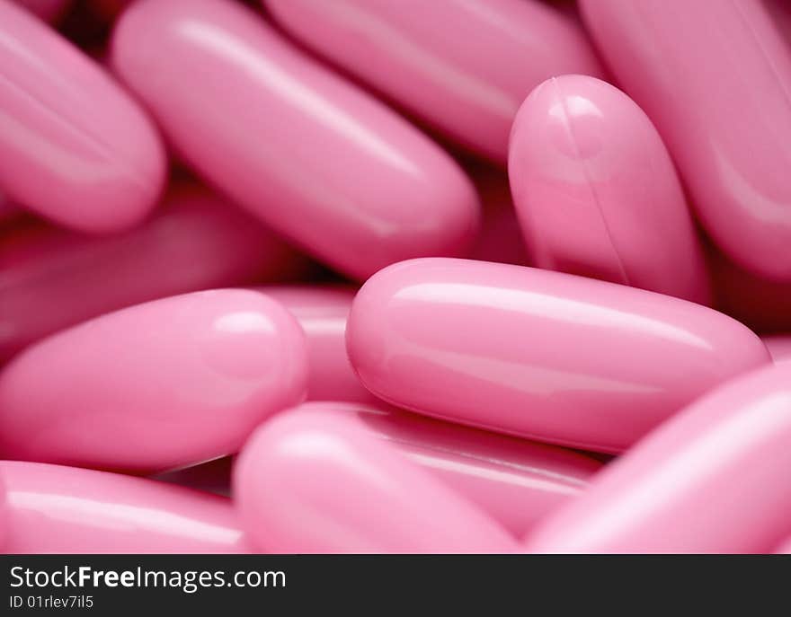 The group of pink capsules helping the healthy lifestyle