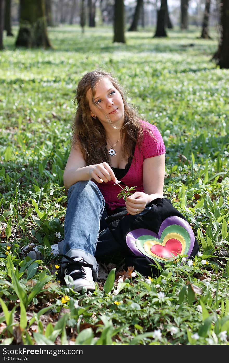 Young dreamy girl sitting in the park. Young dreamy girl sitting in the park