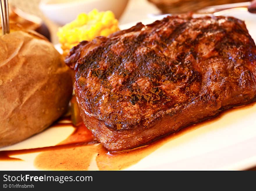 Sirloin strip steak with corn cob ,vegetables and