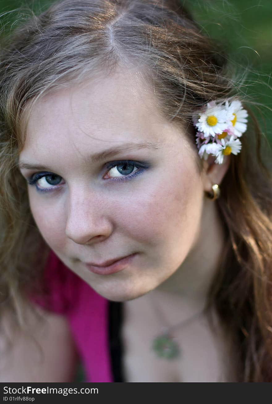 Nice girl with marguerite in her hair