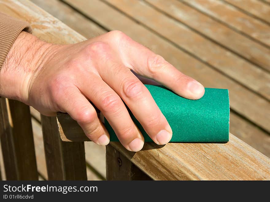 Removing a tint from wooden surface by sendpaper. Removing a tint from wooden surface by sendpaper