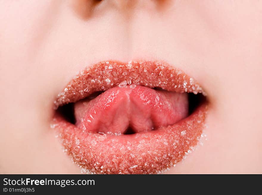 Woman licking spilled sugar from her lips. Woman licking spilled sugar from her lips