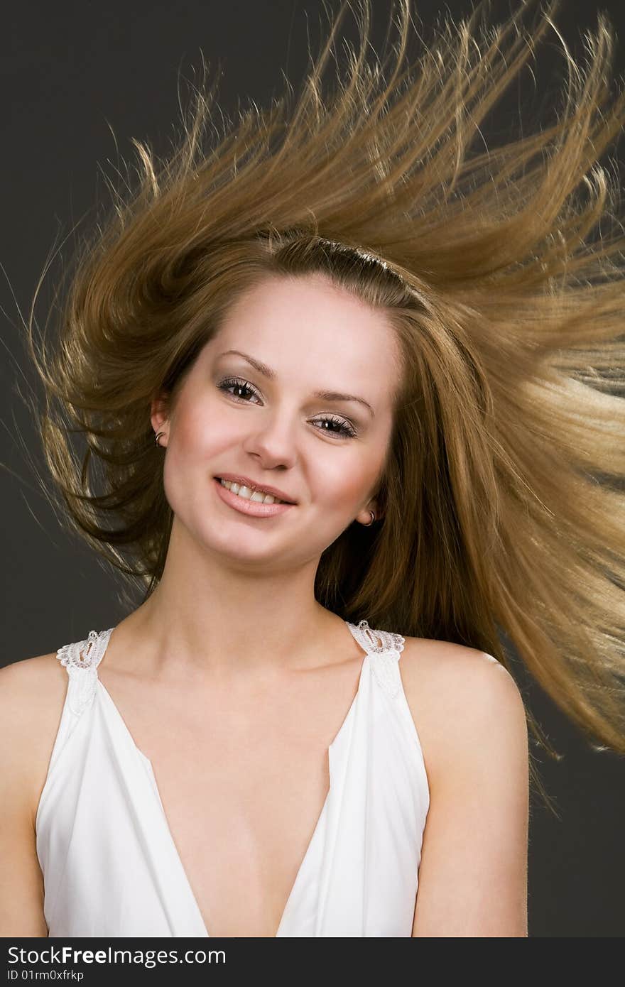 Happy young girl with long flying hair