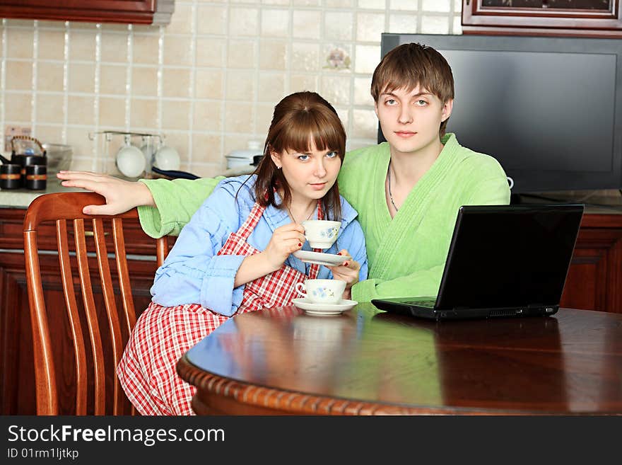 Happy young couple on a kitchen at home. Happy young couple on a kitchen at home.