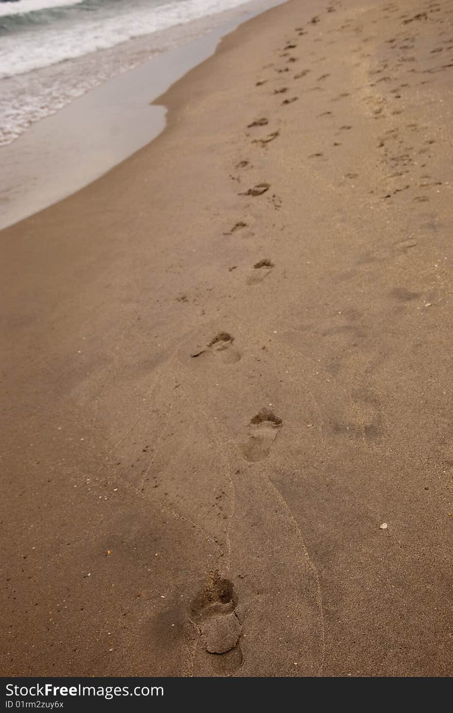 A trail left behind by a barefoot runner. A trail left behind by a barefoot runner