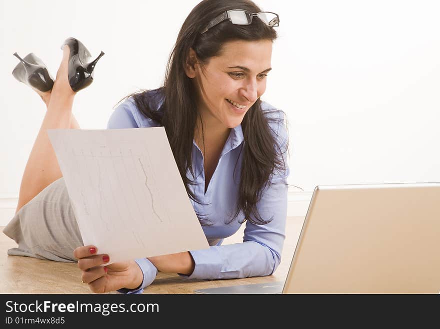 Female professional sitting in casual position with laptop. Female professional sitting in casual position with laptop