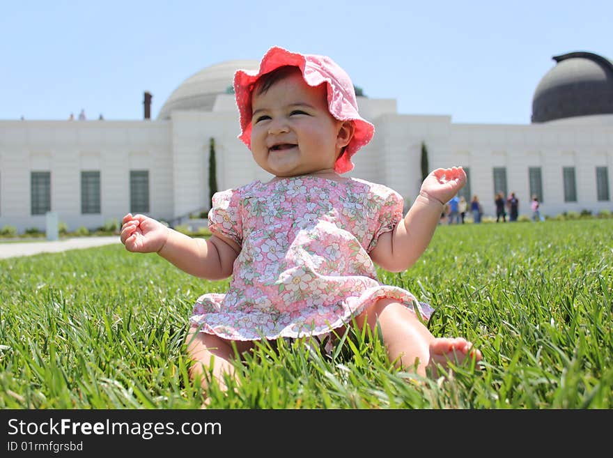 Baby girl sitting on grass