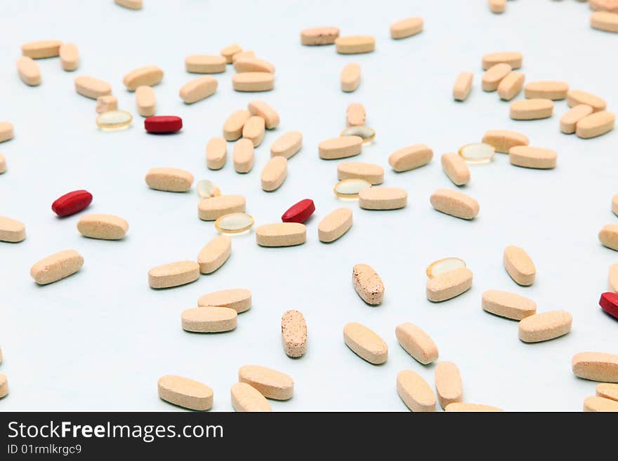 Closeup of many medical pills on a light background. Closeup of many medical pills on a light background