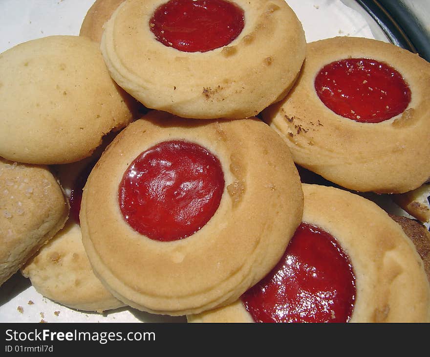 Close up view of some butter cookies with strawberry jam in the middle