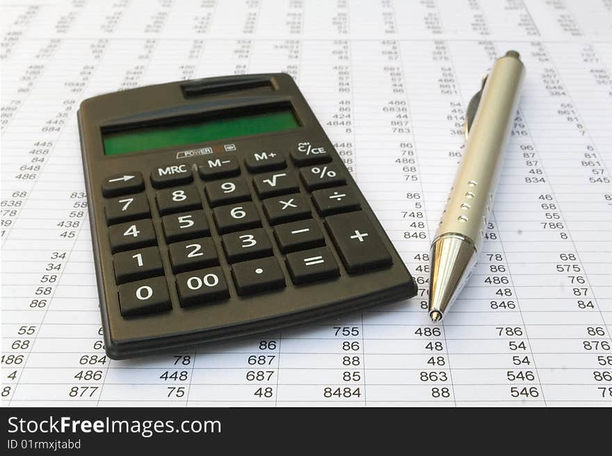 Calculator and pen on a white background. Calculator and pen on a white background