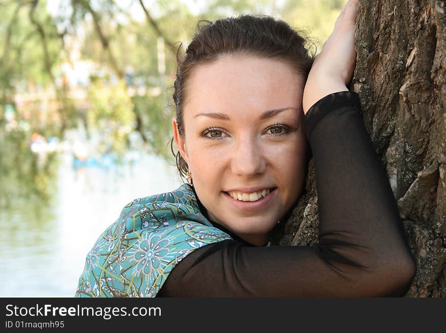 Beautiful woman near tree in the park