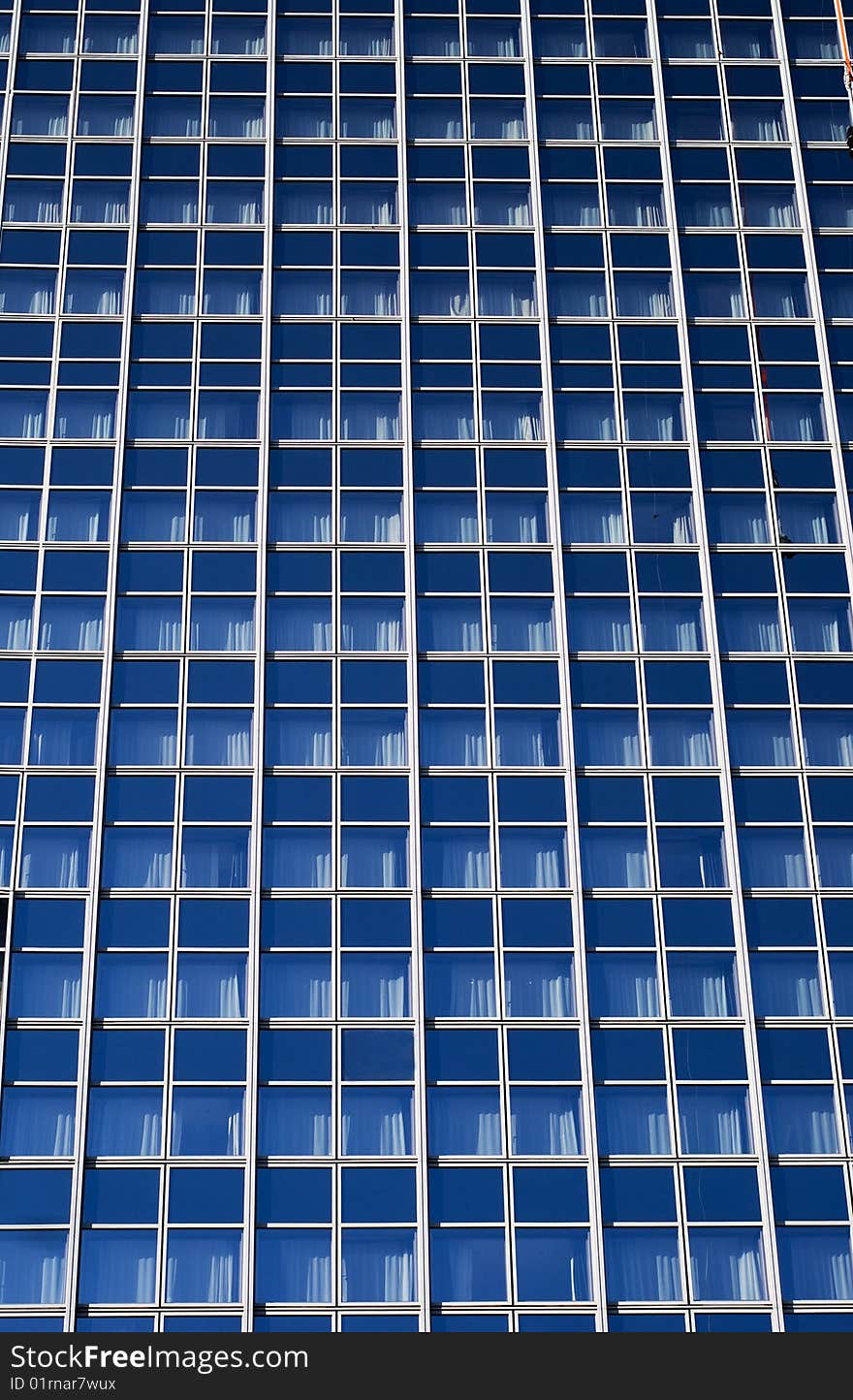 The blue background of the office building with windows. The blue background of the office building with windows