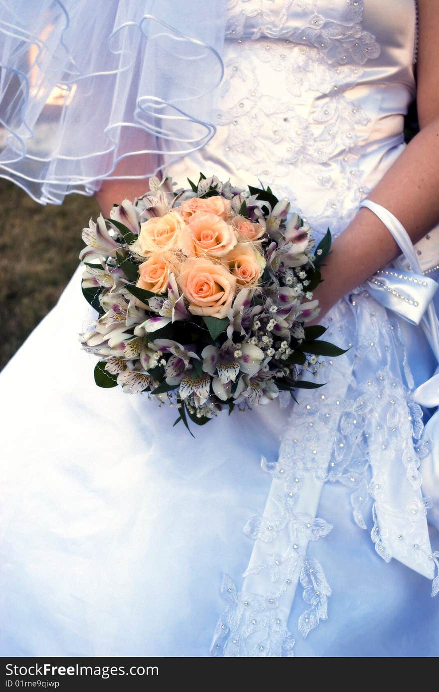 Wedding bouquet with roses in bride's hands