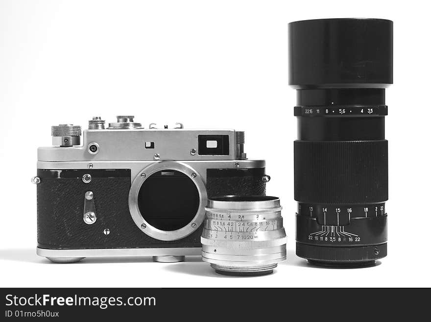 A classic manual film camera and objective, on white. A classic manual film camera and objective, on white.