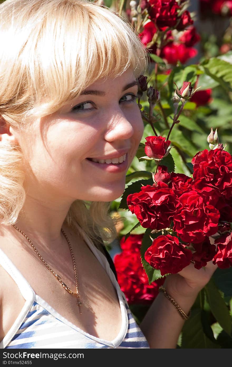 Beautiful woman with roses in park