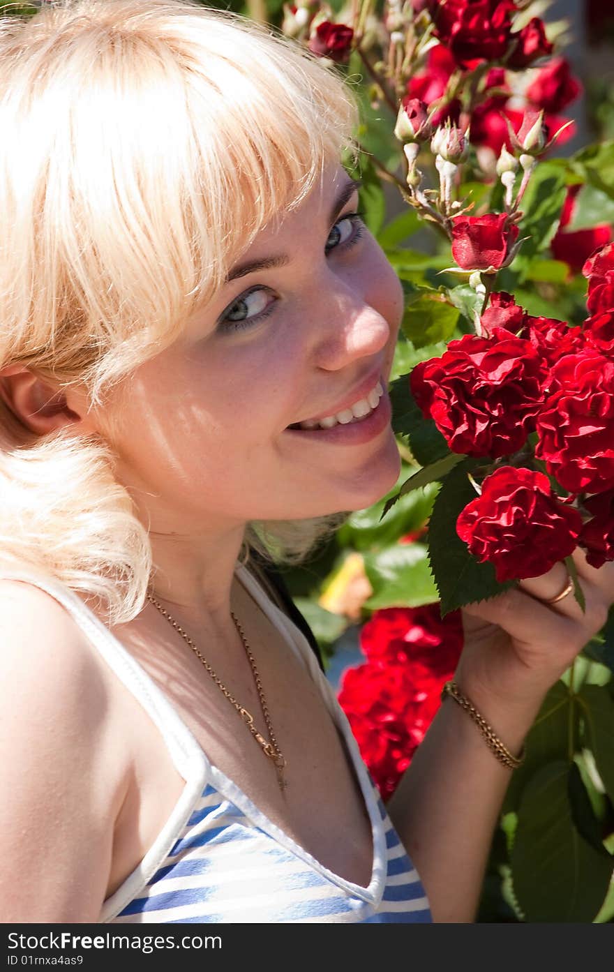 Beautiful woman with roses in park