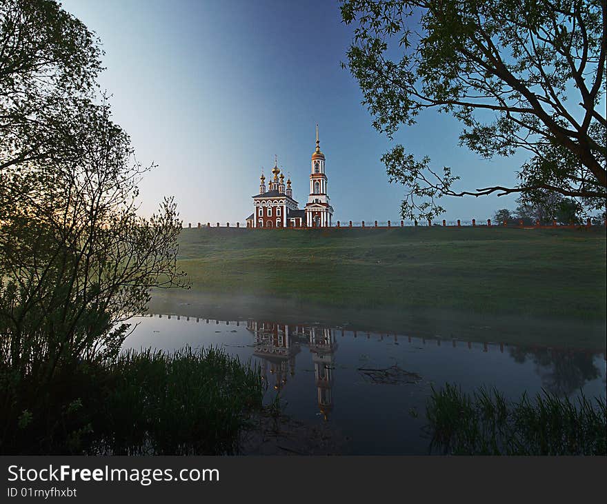 Church on the hill and its reflectrion in foggy river. Church on the hill and its reflectrion in foggy river