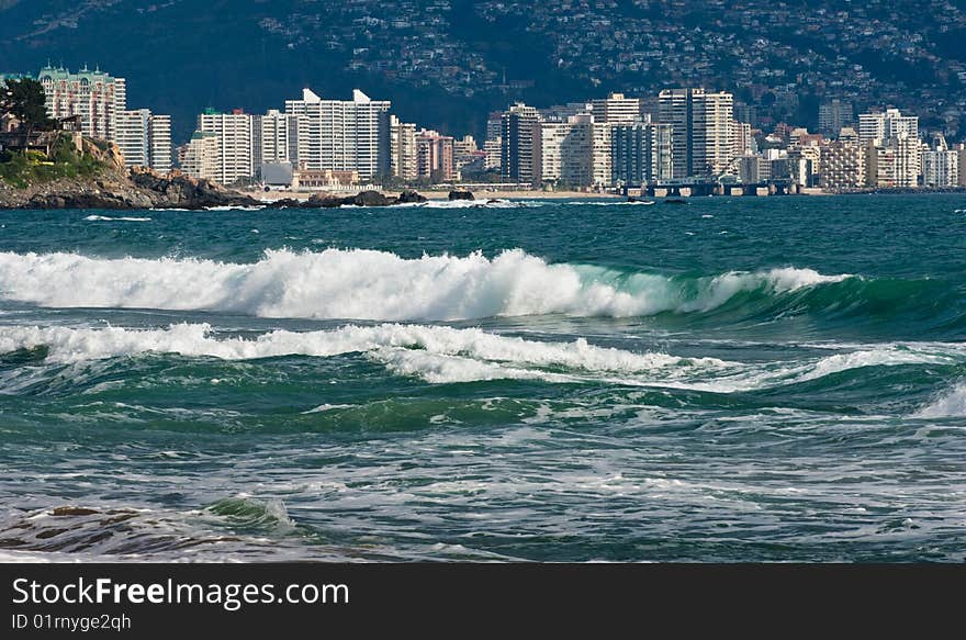 Beach scenes with a cityscape background, Chile.