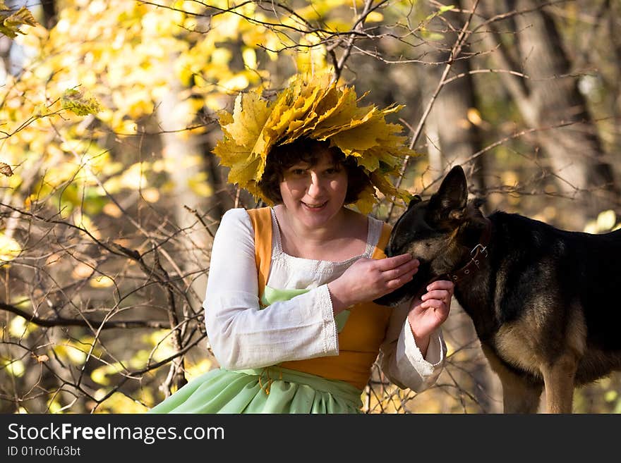 Woman and dog in autumn forest