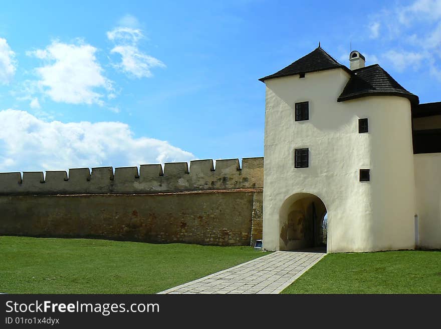 Old gothic defensive gateway with wall. Old gothic defensive gateway with wall